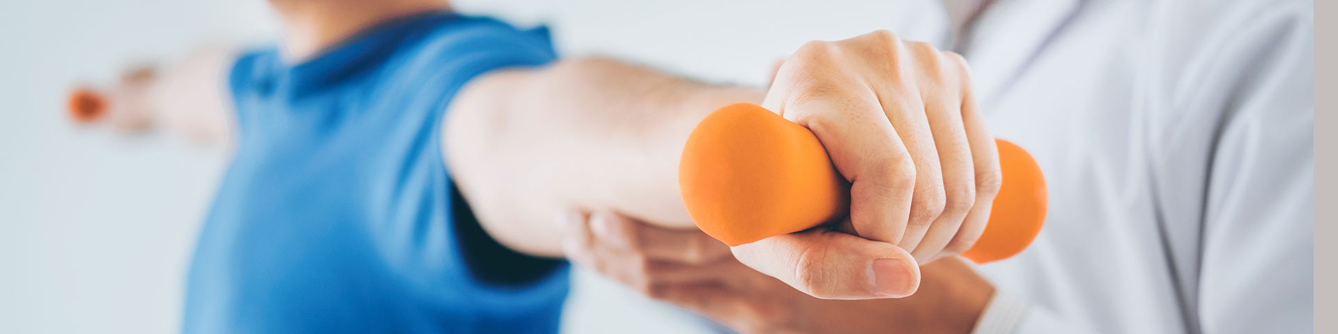 Physiotherapist man giving exercise with dumbbell treatment Abou